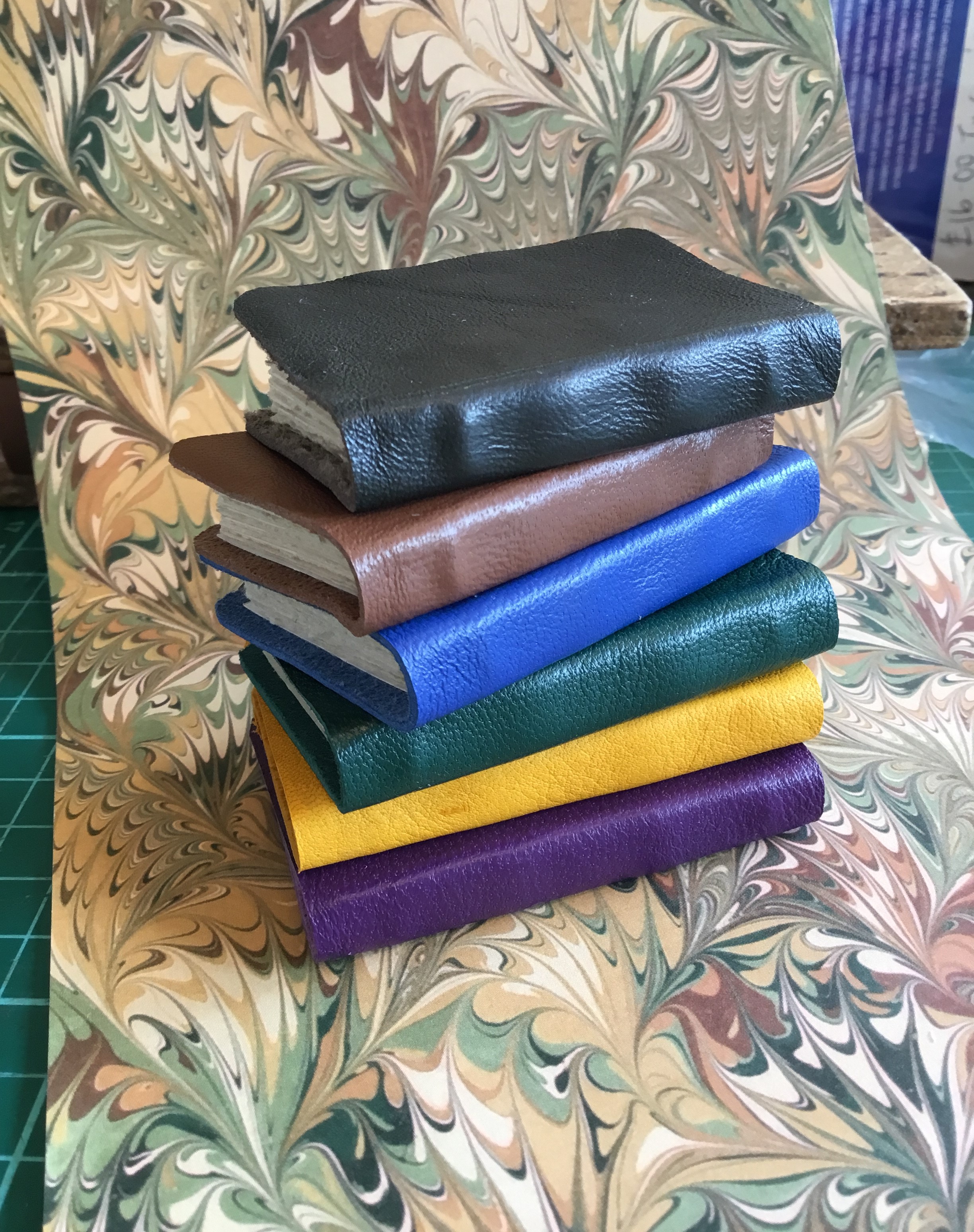 Stack of little softback leather.JPG